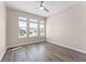 Bright bedroom with three windows and laminate flooring at 1598 Barberry Dr, Kissimmee, FL 34744