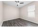 Cozy bedroom with laminate floors, a window, and a ceiling fan at 1598 Barberry Dr, Kissimmee, FL 34744