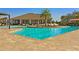 Community pool with sunshades and sunbathing chairs at 1598 Barberry Dr, Kissimmee, FL 34744