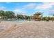 Large community pool area with splash pad, lounge chairs and sunshades on a sunny day at 1598 Barberry Dr, Kissimmee, FL 34744