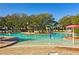Community pool with beach style entry, water features, and shaded lounge chairs at 1598 Barberry Dr, Kissimmee, FL 34744