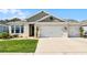 Charming single-story home with a well-manicured lawn and a two-car garage at 1598 Barberry Dr, Kissimmee, FL 34744
