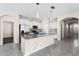 Bright and open kitchen with a granite island, stainless appliances, and a view into the living area at 1598 Barberry Dr, Kissimmee, FL 34744