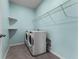 Laundry room with washer, dryer and wire shelving at 1598 Barberry Dr, Kissimmee, FL 34744