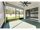 Relaxing screened-in patio with ceiling fan and views of the backyard and white vinyl fence at 1598 Barberry Dr, Kissimmee, FL 34744