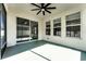 Covered patio with fan, sliding glass doors, and many windows providing sunlight at 1598 Barberry Dr, Kissimmee, FL 34744