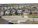 Community aerial showcasing the neighborhood, nearby pool, and modern homes with solar panels at 1763 Standing Rock Cir, Oakland, FL 34787