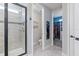 Modern bathroom featuring a glass enclosed shower with decorative tile accents and a walk-in closet at 1763 Standing Rock Cir, Oakland, FL 34787