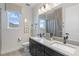 Bathroom featuring a double vanity, modern fixtures, and ample natural light at 1763 Standing Rock Cir, Oakland, FL 34787