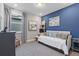 Bright bedroom with a blue accent wall, stylish furnishings, and cozy daybed at 1763 Standing Rock Cir, Oakland, FL 34787