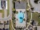 Overhead shot of a community pool with many lounge chairs and palm trees around the edge, with a jacuzzi at 1763 Standing Rock Cir, Oakland, FL 34787