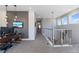 Upstairs hallway with an office, decorative wall, railing, and natural light from the windows at 1763 Standing Rock Cir, Oakland, FL 34787