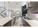 Open-concept kitchen with stainless steel appliances, large island, and seamless flow into the living area at 1763 Standing Rock Cir, Oakland, FL 34787
