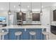 Modern kitchen boasts a large island with seating, sleek cabinetry, and stainless steel appliances at 1763 Standing Rock Cir, Oakland, FL 34787