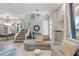 Open-concept living room with modern staircase, sleek furniture, and abundant natural light at 1763 Standing Rock Cir, Oakland, FL 34787