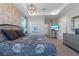 Bedroom boasts wallpaper, chandelier, and natural light from large windows at 1763 Standing Rock Cir, Oakland, FL 34787