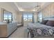 Serene main bedroom with tray ceiling, natural light, and stylish furnishings create a relaxing space at 1763 Standing Rock Cir, Oakland, FL 34787