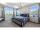 Comfortable main bedroom features a large window, tray ceiling, and neutral color palette at 1763 Standing Rock Cir, Oakland, FL 34787