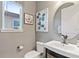 Elegant powder room features a modern vanity, round mirror, and neutral wall color at 1763 Standing Rock Cir, Oakland, FL 34787
