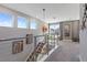 Upstairs landing with stylish art pieces and a modern staircase featuring metal and cable railings at 1763 Standing Rock Cir, Oakland, FL 34787