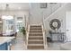 Elegant staircase with metal railing, bright windows, and stylish decor showcasing an open layout at 1763 Standing Rock Cir, Oakland, FL 34787