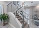 Contemporary staircase with metal railings and carpeted steps, leading to upper levels of the home at 1763 Standing Rock Cir, Oakland, FL 34787