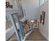 Modern staircase featuring metal railings, neutral-colored carpet and decor at 1763 Standing Rock Cir, Oakland, FL 34787