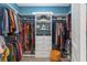 Organized walk-in closet with shelving, drawers, and hanging storage at 1763 Standing Rock Cir, Oakland, FL 34787
