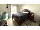 Bedroom with a comfortable bed, tile flooring, and a window providing natural light at 1866 Caralee Blvd # 3, Orlando, FL 32822