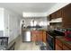 Spacious kitchen with dark cabinetry, stainless steel appliances, and a view to the living space at 1866 Caralee Blvd # 3, Orlando, FL 32822