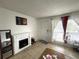 Bright living room featuring a fireplace, neutral tile floors, and a large window for natural light at 1866 Caralee Blvd # 3, Orlando, FL 32822