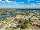 Expansive aerial view of a lakeside community with lush foliage and diverse housing options at 2031 Roseway Ave, Deltona, FL 32738