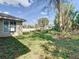 Wide backyard view featuring a well-kept lawn, mature trees, and partial fencing, creating a serene setting at 2031 Roseway Ave, Deltona, FL 32738