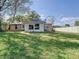 Spacious backyard with green grass and partial white fencing, offering privacy and room for outdoor activities at 2031 Roseway Ave, Deltona, FL 32738