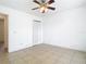 Bright bedroom features a ceiling fan, tile flooring and closet space at 2031 Roseway Ave, Deltona, FL 32738