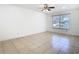 Bright bedroom featuring a ceiling fan and a large window, creating a simple yet functional space at 2031 Roseway Ave, Deltona, FL 32738