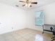 Bright bedroom featuring a ceiling fan, window, and desk, creating a simple yet functional space at 2031 Roseway Ave, Deltona, FL 32738