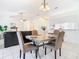 Cozy dining area with tile floors adjacent to the living room, featuring a stylish table and chairs at 2031 Roseway Ave, Deltona, FL 32738