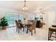 Bright dining area featuring tile floors, a stylish table setting, and natural light from the sliding glass doors at 2031 Roseway Ave, Deltona, FL 32738