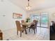 Elegant dining room with tile flooring, a modern table set for four, and ample natural light at 2031 Roseway Ave, Deltona, FL 32738
