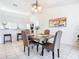 Open-concept dining space with tile floors, modern table, and a view into the adjacent kitchen area at 2031 Roseway Ave, Deltona, FL 32738