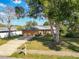 Inviting single-Gathering home with brick facade, mature trees, a well-kept lawn, and a two-car garage at 2031 Roseway Ave, Deltona, FL 32738