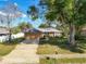 Well-maintained home featuring an attached garage, a large driveway, and a cozy front yard at 2031 Roseway Ave, Deltona, FL 32738