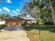 Beautiful single-story home with well-maintained lawn and landscaping, featuring brick facade and mature trees at 2031 Roseway Ave, Deltona, FL 32738