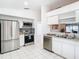 Modern kitchen features stainless steel appliances, granite countertops, and ample white cabinetry at 2031 Roseway Ave, Deltona, FL 32738