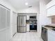Efficient kitchen features stainless steel appliances, granite counters, and ample storage in white cabinets at 2031 Roseway Ave, Deltona, FL 32738
