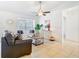 Bright and airy living room with tile flooring, a comfortable sofa, and a large window providing natural light at 2031 Roseway Ave, Deltona, FL 32738