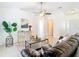 Inviting living space with tile floors, comfortable leather sofa, and bright natural light at 2031 Roseway Ave, Deltona, FL 32738