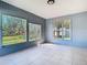 Comfortable sun room with views of the large backyard and natural light from multiple windows at 2031 Roseway Ave, Deltona, FL 32738