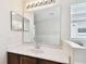 Bathroom vanity with white countertop, chrome faucet, and large mirror at 2136 Shadow Creek Dr, Kissimmee, FL 34746